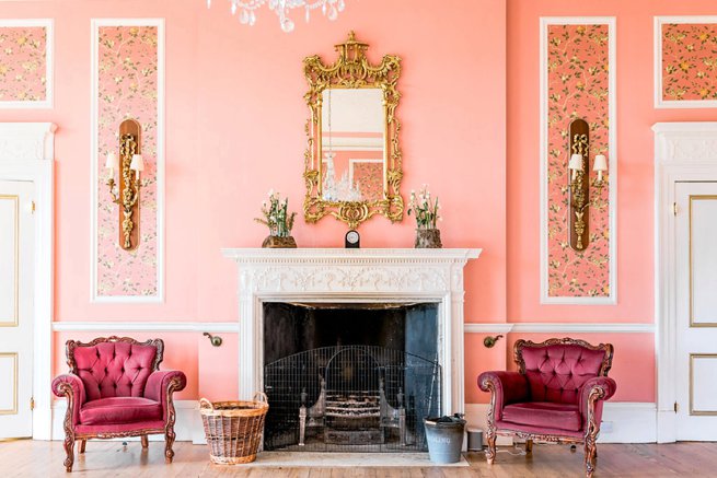 Interior room pink chairs by fire place | Kelly Chandler Consulting