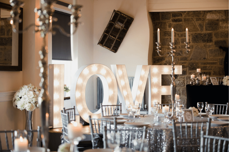 Large light alphabet marquee letters saying love more wedding venue revenue