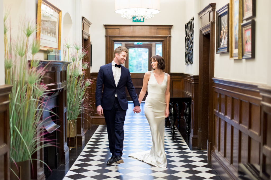 bride and groom walking in a country house turned wedding venue