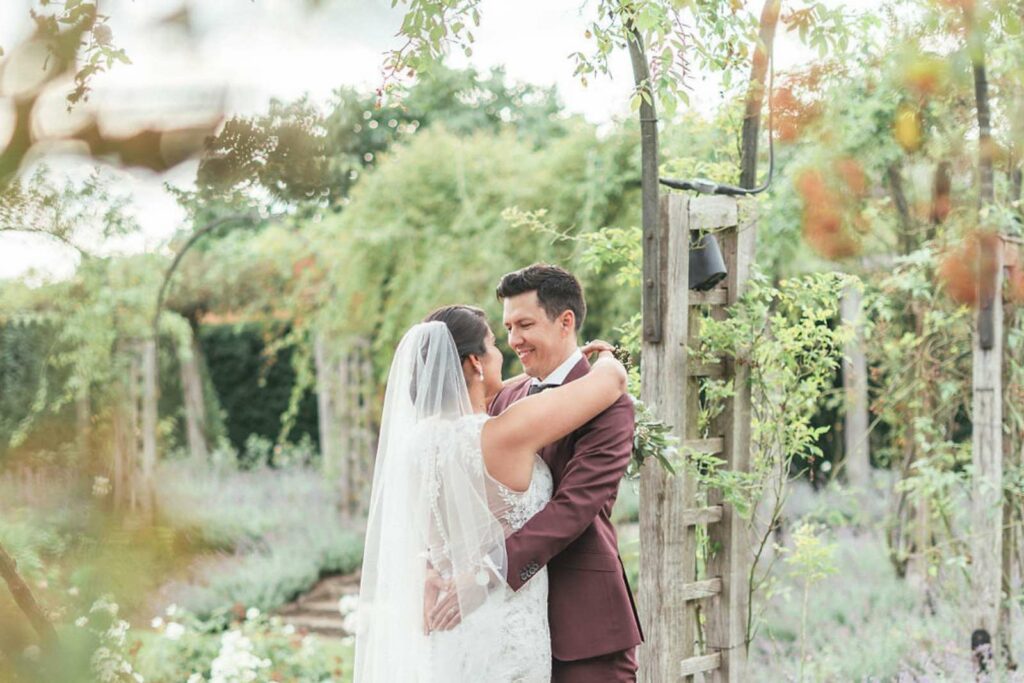 Bride and groom posing outdoors in a beautiful garden