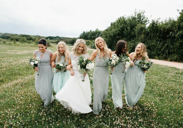 Bride and bridesmaids walking and laughing | Kelly Chandler Consulting