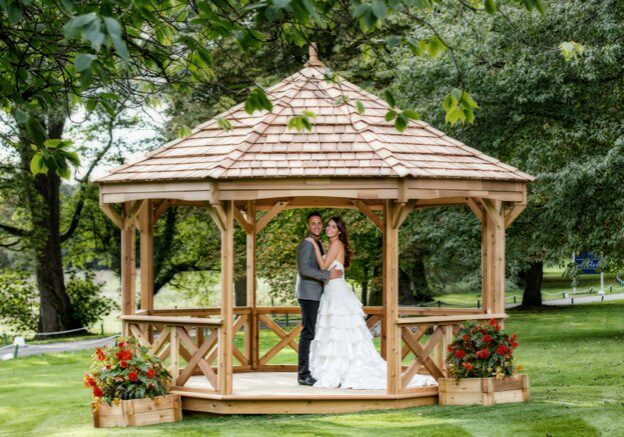 Bride and groom under a gazebo | Kelly Chandler Consulting