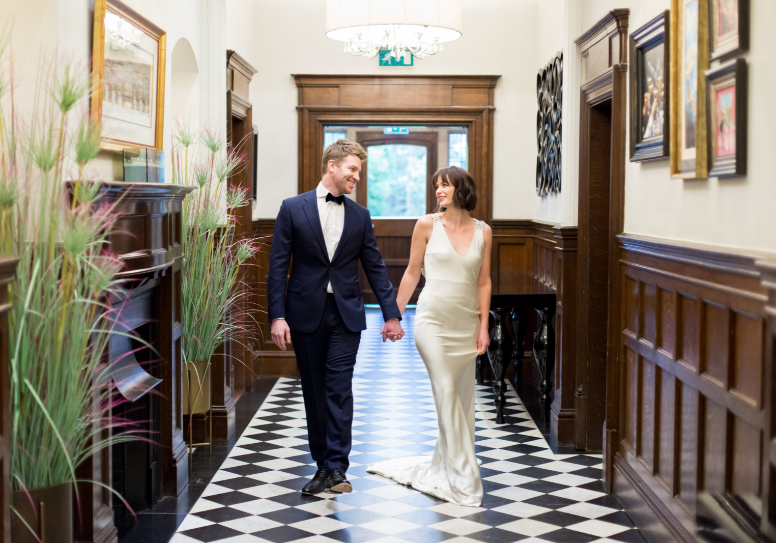 bride and groom walking in a country house turned wedding venue